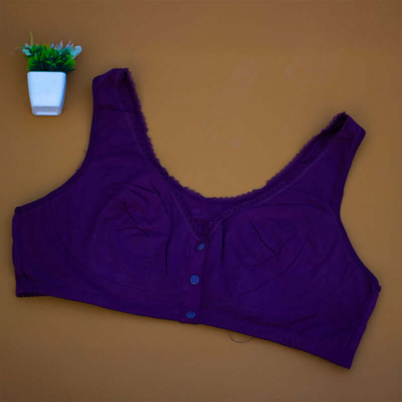 Wide strap front open 3-button nursing bra in purple cotton-lycra with a small plant beside it.