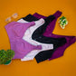 Wide strap nursing bras in pink, black, and purple colors on an orange background, designed for comfort and breastfeeding.
