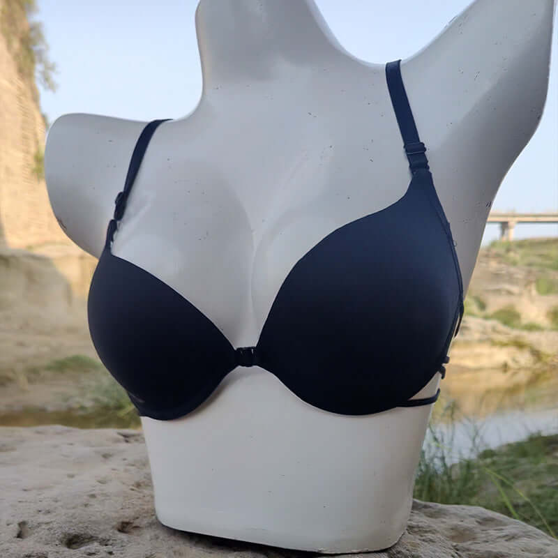Navy push-up bra on a mannequin against a scenic outdoor backdrop, showcasing elegant support and style.